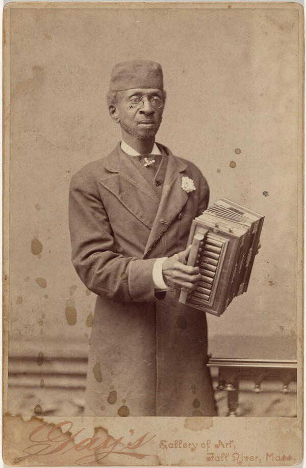 Portrait of a Man Holding an Accordion