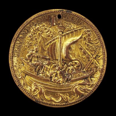 A photograph of a gold-colored medallion is shown. The medallion depicts a ship with a sail surrounded by waves and clouds. Figures on the ship are engaged in activities. The relief work is detailed, particularly in the figures and sail. An inscription in a classical style frames the scene on the edge of the medallion. The craftsmanship suggests a historical or commemorative purpose, highlighting fine artistry and detailed representation.