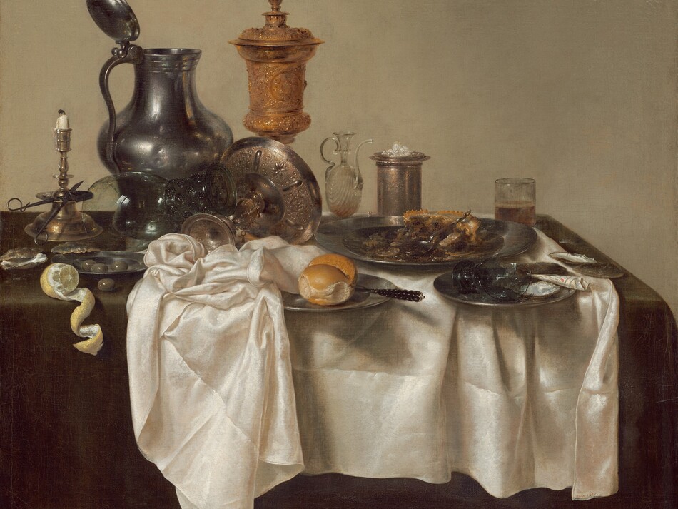 A jumble of pewter plates and a pitcher, glass goblets, a gold chalice, a brass candlestick, and other vessels along with lemons, olives, and the remains of a mince pie are arranged on a cream-white tablecloth bunched on a dark green tabletop in this square still life painting. The scene is painted almost entirely in shades of cool grays, gold, brown, and white against a deep beige background. The objects span width of the canvas across its center. At the left edge of the painting, a vibrant yellow lemon has been cut so its rind curls in a spiral that hangs over the front edge of the table. Behind the lemon, a scissor-like candle snuffer is propped against the wide ledge of the tall brass candlestick, its white candle nearly burned down. A few glistening olives sit in a small pewter plate, and one olive sits on the tabletop near the lemon and candlestick. A glass goblet with a wide stem with textured knubs rests upended on an elaborately chased, gold, footed vessel that has been tipped over so its wide shallow bowl faces away from us. The tall pewter pitcher behind this is dented on its rounded body. The lidded gold chalice next to the jug is the tallest object in the painting. Next to the chalice, along the right half of the painting, is a glass oil cruet with a long, curving spout, a tall, cylindrical vessel holding a small pile of salt, and a straight-sided, low glass holding beer. In front of these objects, an untouched bread roll and knife sit on a pewter plate at the center of the composition. The remains of the mince pie with its pastry crust sit on a large pewter plate to our right. In front of it is a smaller plate holding a broken goblet and a piece of black and white paper rolled into a cone. A few empty oyster shells sit on the table to the left and right, near the lemons and mince pie. The artist signed and dated the painting along the edge of the white cloth near the lower right corner: “HEDA 1635.”