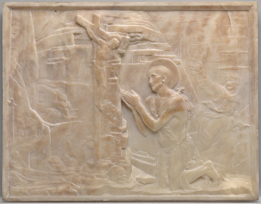 A man wearing a cloak tied around his body kneels with his hands together at the foot of a crucifix, set against a rocky outcropping on this stone panel. The scene is shallowly carved in low relief from pale, apricot-peach marble. Both the kneeling man, Saint Jerome, and the man hanging on the cross have raised, disk-like halos. Slightly right of center, the kneeling man looks up at the cross from under heavy brows. He has hollow cheekbones and short hair. His robe is tied over his shoulders and falls across his hips, but his feet and slender arms are bare. The man on the cross is smaller in scale, less than half the size of Saint Jerome. He hangs heavily from his hands, which are nailed into the cross, and his head falls forward. He is nude except for a loincloth across his hips. A rocky, hut-like form fills the space behind Saint Jerome. A few details are lightly carved so are visible only on closer inspection. These include a smaller cross along the left edge of the panel and a skull at the base of the crucifix. Between the crucifix and rocky structure, a male and female lion run toward Saint Jerome, mouths open. In the space between Saint Jerome and the right edge of the panel, another person is lightly carved into the background. He runs to our right while looking back over one shoulder, perhaps at the lions. One hand is flung high, his mouth wide open, and his hair stands on end. His voluminous robe flutters around his body. Beyond him, triangular trees recede into the distance under a cloud-streaked sky.
