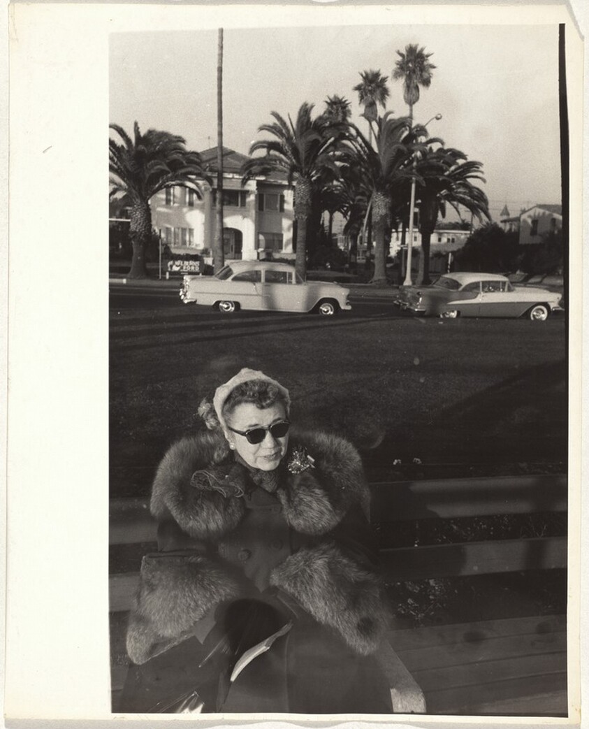 Woman seated on bench--Los Angeles