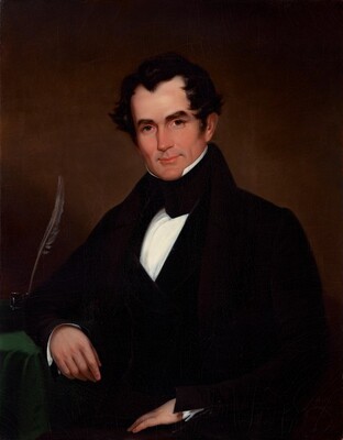The image displays a man's upper body. He is seated at a slight angle to the left, with one arm resting on a surface covered by a green cloth. The man has a composed expression, with defined facial features, including dark arched eyebrows, a high forehead, and short, dark hair with a subtle wave. He is dressed in formal attire, consisting of a black coat, a white shirt, and a cravat. A quill is placed nearby. The background is a plain, muted brown color.
