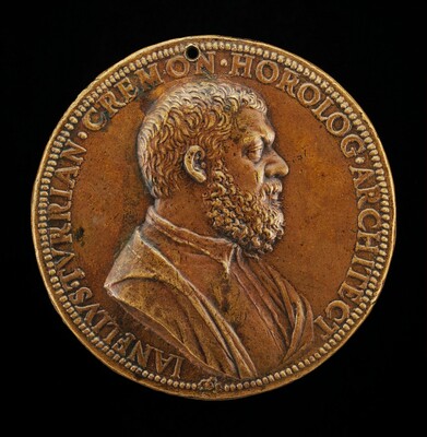 The image depicts a round bronze medallion with a relief sculpture of a man's profile looking to the right. The subject is a male figure with curly, short hair and a full beard. He is depicted wearing a garment with a collar visible at the neckline. The sculpture is rendered in bronze, giving it a warm, golden-brown color with some darker patina. Surrounding the profile is a border with an inscription that reads, "IAN.ELVSJ.VIRIAN.CREMON.HOROLOG.ARCHITECT." A small hole is present at the top of the medallion. The craftsmanship is detailed, providing a realistic portrayal of the subject.