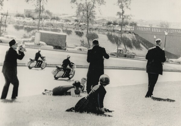 Title from caption on object: “Spectators Hug the Ground...”