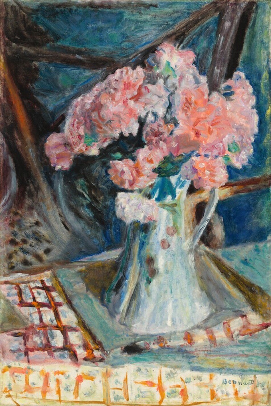 A bouquet of about a dozen ruffled, frilly, pink flowers in a white pitcher painted with blue undertones nearly fills this vertical still-life composition. Brushstrokes are loose throughout so many details are difficult to make out. The bouquet sits right of center atop a table layered with brick red, pumpkin orange, marigold yellow, and ivory white patterned cloths. The background is especially loosely painted with strokes of celestial blue, teal green, burnt orange, and ash brown. Some upright brown strokes could represent the back of a wood chair. The artist signed the work in the lower right corner, “Bonnard.”