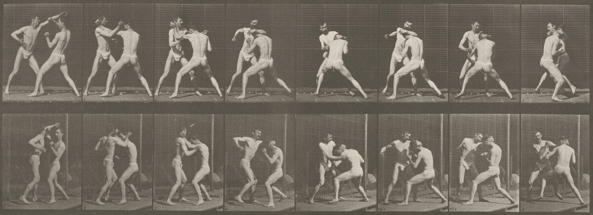 This is a photograph of a sequential depiction of an athletic activity. The photograph shows a series of frames with two rows, each capturing moments in a motion sequence. The images present two figures in motion, engaged in a form of sparring or wrestling. The background has a plain, grid-like pattern. The series captures different stages of the interaction between the figures, highlighting their dynamic movements and positions.