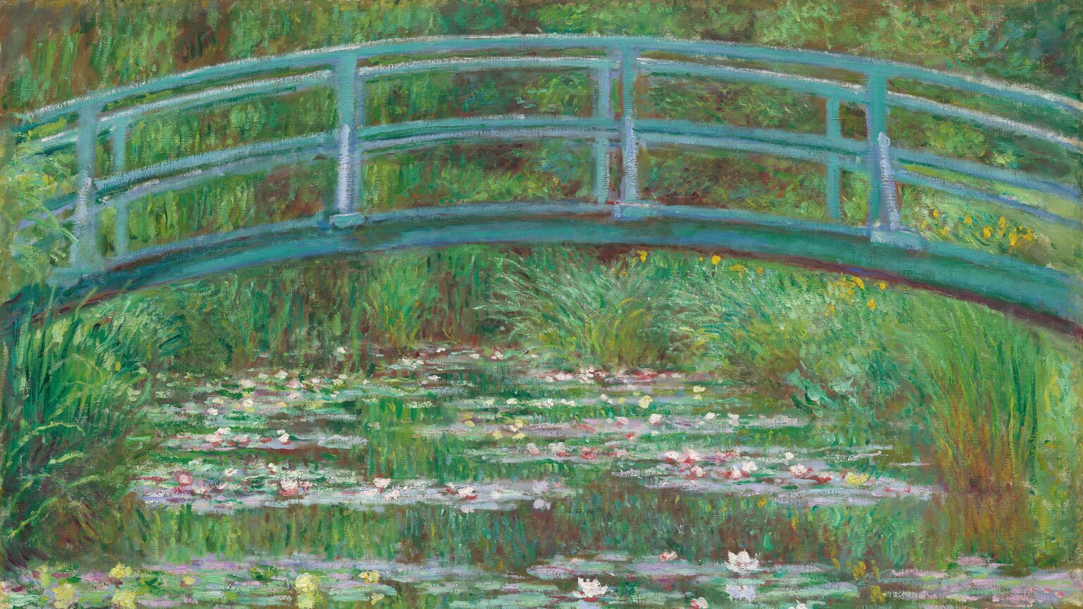 A pale turquoise footbridge arching over a pond lined with tall grasses and filled with petal-pink and butter-yellow waterlilies spans this horizontal landscape painting. The scene is loosely painted with touches of vibrant color. In the top third of the composition, the shallowly arched bridge nearly touches the top edge of the canvas, and it extends off each side. The shadows on the bridge are painted with eggplant purple. Bands of waterlilies gently zigzag into the distance on the surface of the water. The spring and emerald-green grasses growing along the banks fill the space around and over the pond, and they blend into a screen of trees beyond that enclose the scene. The green of the grasses and trees is reflected in the surface of the water, as is the underside of the bridge. The artist signed and dated the work with dark paint in the lower right corner: “Claude Monet 99.”