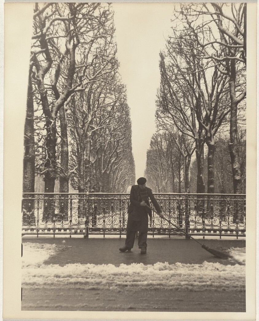 Man sweeping snow from sidewalk, Paris