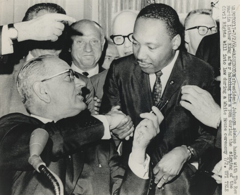 Title from caption on object: “President Johnson Shakes Hands with the Reverend Martin Luther King...”