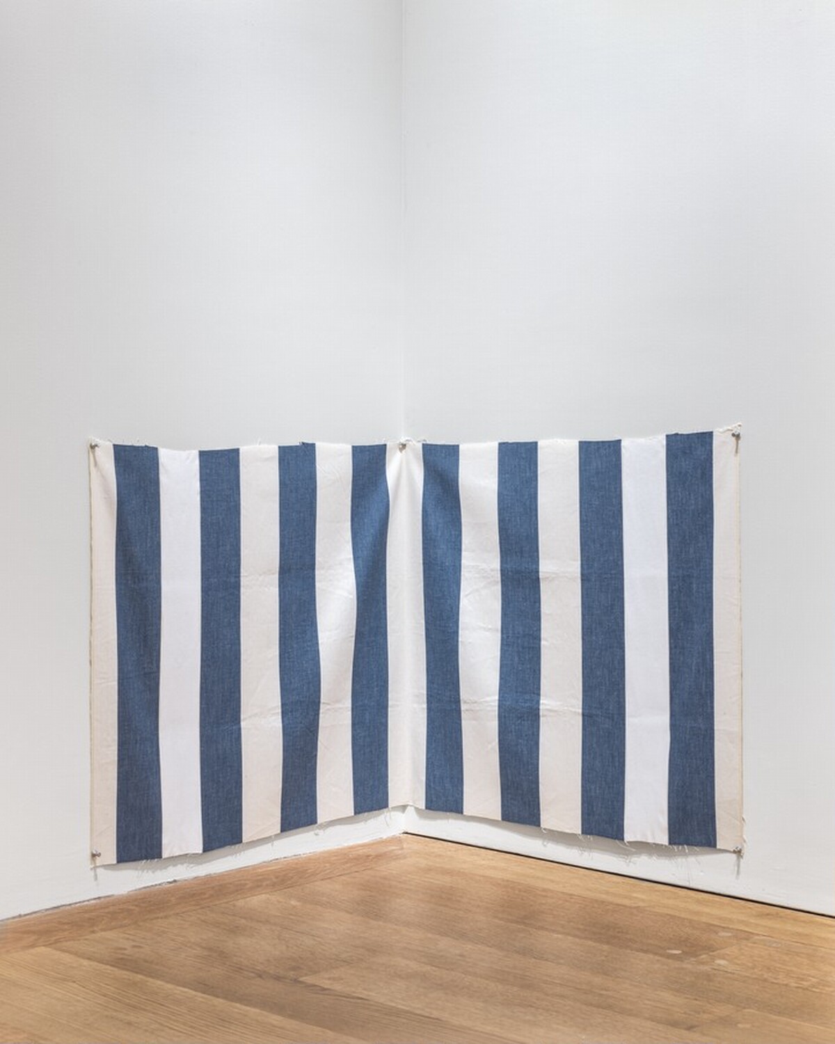 White acrylic paint on white and blue striped cloth