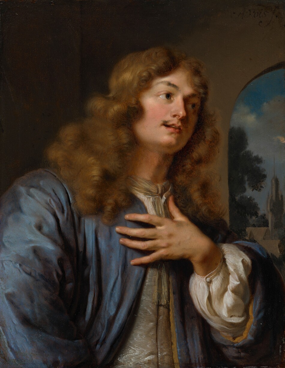 This painting is a portrait of a person depicted from the waist up, turned slightly to the right with one hand raised to their chest. The person has pale skin, rosy cheeks, a thin mustache, and long, curly brown hair. They are wearing a loose, long-sleeved blue garment on top of a billowing white shirt. The background features a dark interior space with an arched window on the right, through which a landscape with trees and a distant spire is visible under a blue sky.