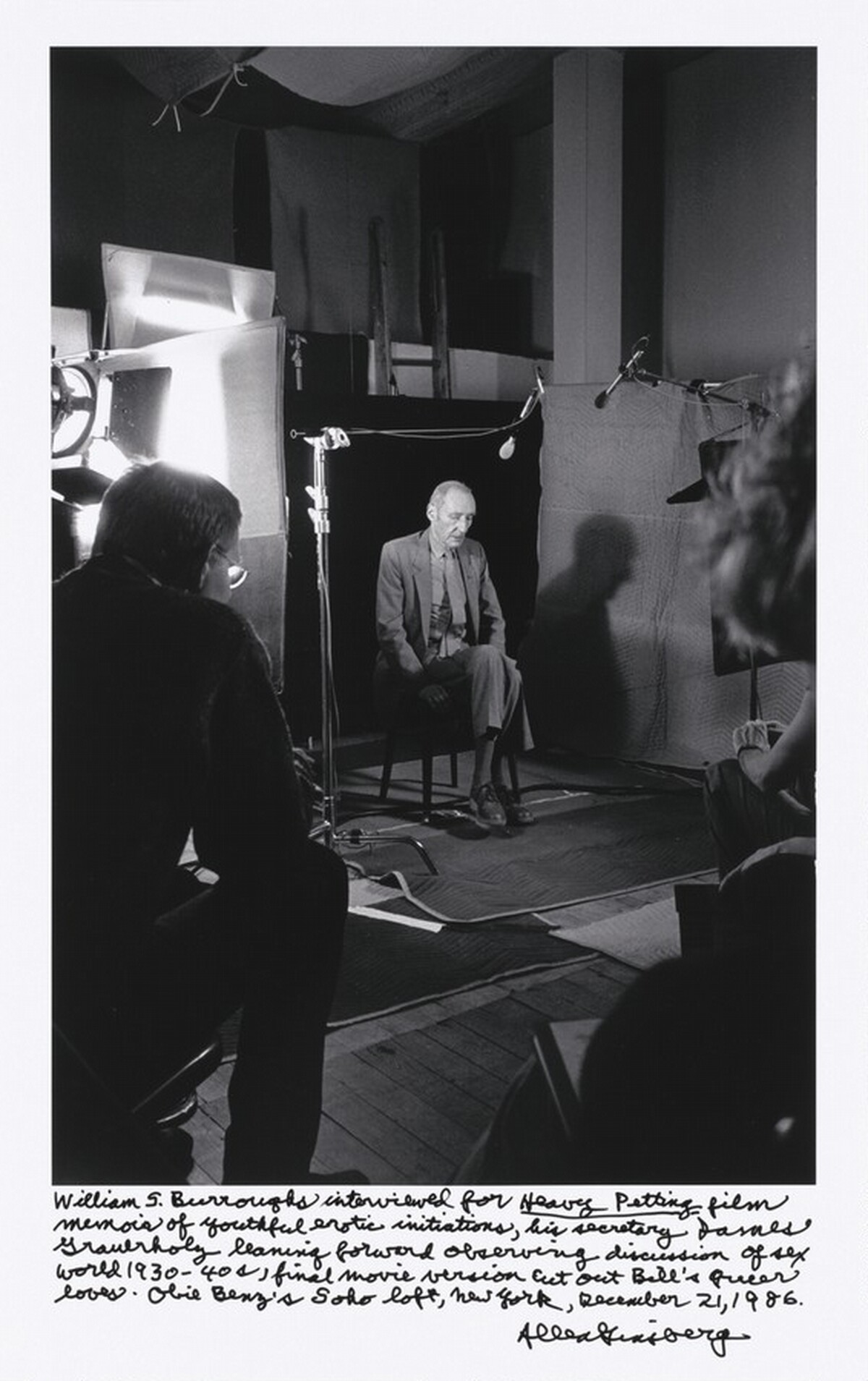 William S. Burroughs interviewed for _Heavy Petting_ film memoir of youthful erotic initiations, his secretary James Grauerholz leaning forward observing discussion of sex world 1930 – 40s, final movie version cut out Bill’s queer loves. Obie Benz’s Soho loft, New York, December 21, 1986.