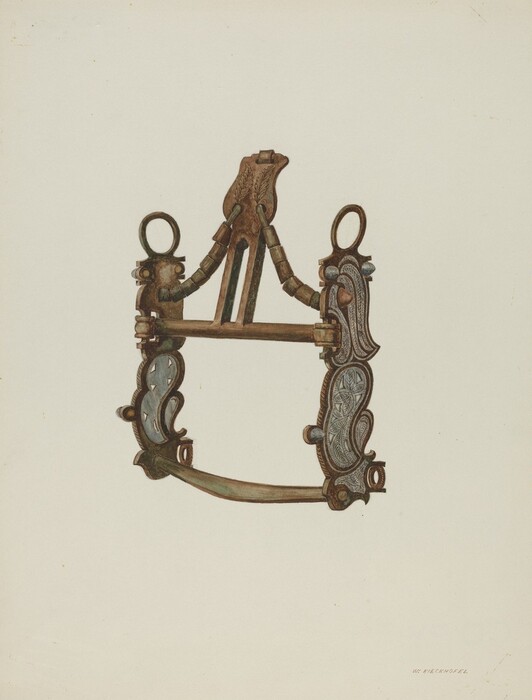 The image shows a metallic object with an intricate symmetrical design. The object appears to be a piece of harness hardware or a decorative fitting. It has a bronze or copper color with some areas showing a greenish tint from oxidation. The object is placed on a light-beige background and has a narrow upper section, widening towards the bottom, connected by ornate brackets and loops. Detailed carvings and patterns are evenly distributed on both sides of the object.