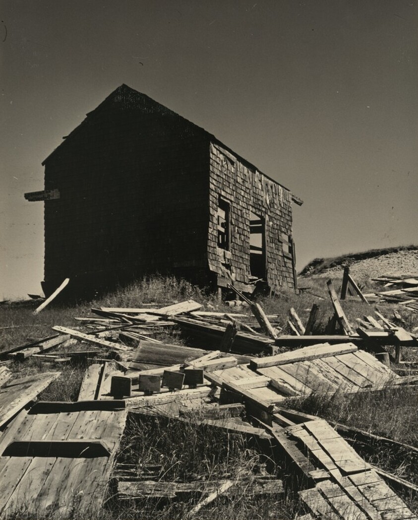 Shingled House with Debris in Yard