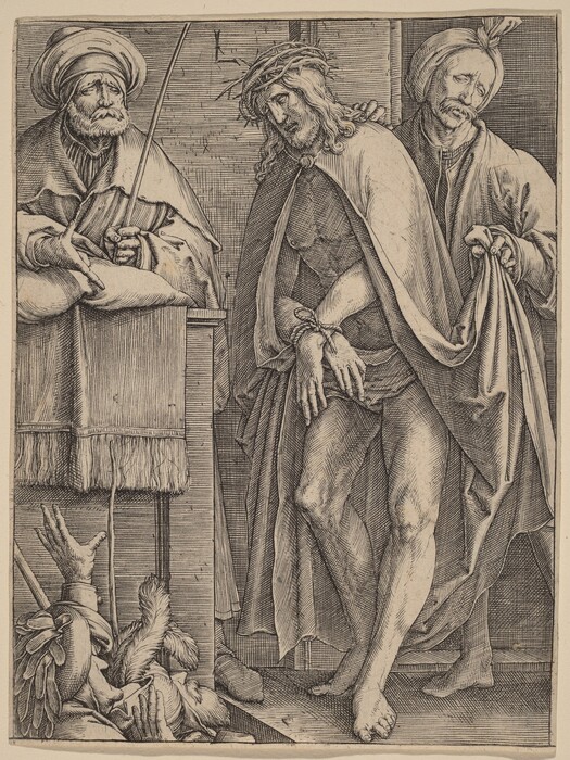 The image depicts three individuals. The central figure is standing with hands bound in front, wearing a crown of thorns and a cloak that covers the upper body. The figure to the left appears seated or leaning, wearing a turban and holding a staff. The third individual on the right is partially visible, standing, wearing a turban, and holding the back of the central figure's cloak. The background shows a brick-like pattern.
