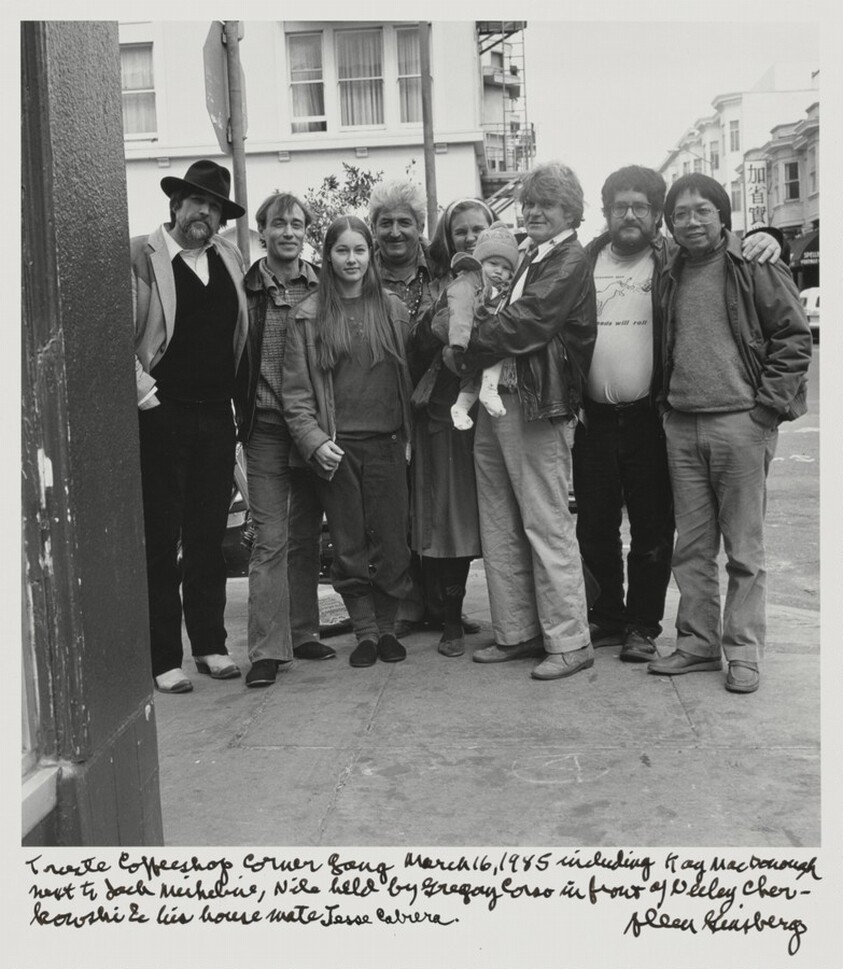 Trieste Coffeeshop Corner Gang March 16, 1985 including Kaye MacDonough next to Jack Micheline, Nile held by Gregory Corso in front of Neeli Cherkovski and his house mate Jesse Cabrera.