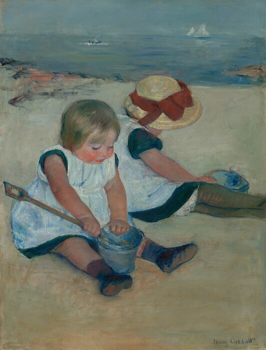 Two pale-skinned little girls sit back-to-back on a sandy beach, almost filling the width of this vertical painting. The girls wear matching pale, ice-blue pinafores over short sleeve, ocean-blue dresses. Both sit with their legs stretched in front of them and angled to our right. The girl closest to us, to our left, looks down at the denim-blue pail and wooden shovel she holds between her ankles. She holds the long-handled shovel in her near hand with the end inside the pail. She has a chubby, flushed, round face with blond hair and rosy arms and legs. She wears black shoes and appears to have a brown sock on her near leg but a dark blue sock on the other. Her companion sits just beyond her and to our right with her body turned away from us. Her wide-brimmed straw hat is trimmed with a tomato-red ribbon tied in a bow at the front. The hat hides her face, and her outstretched legs are encased in olive-green stockings. Her near hand reaches across her lap to grab the pail sitting on the far side of her legs. The beach meets the pale blue and aquamarine ocean in the upper third of the painting. A patch of strokes and daubs of dark blue and peach near the upper left and a tan wedge in the water to our right are painted loosely along the shoreline. Two white sailboats and a horizontal white dash with three dark blue dots drift on the water. The artist signed the lower right, “Mary Cassatt.”