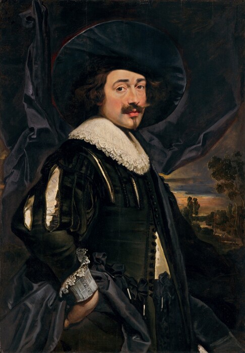 Shown from the hips up, a pale-skinned man with a Van Dyck beard stands with one hand on his hip in this vertical portrait painting. The man’s body faces our right almost in profile, but he turns his head to look at us from the corners of his brown eyes under lifted, black brows. The bridge of his nose is slightly flattened, and he has full pink lips, a pointed chin, and chin-length, wavy black hair. His mustache flares upward at the ends, and a line of hair grows down his chin. The wide brim of his hat would nearly have reached his shoulders, but it sits angled on the back of his head. Layers of white lace create a round collar resting on his chest over a black jacket. The coat is slashed over the chest and upper arms of the sleeves so the white shirt underneath is visible. The jacket is also partially unbuttoned over his torso. The cuff we can see reaches from his wrist along his forearm and is edged in lace. The back of that hand rests against that hip, and the cloth of a black cloak is bunched up around that hand. Black drapery fills most of the background but is pulled back to our right to reveal a landscape with a sunset-streaked sky.