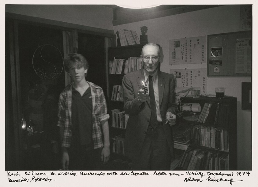 Rudi DiPrima & William Burroughs with his cigarette lighter gun -- Varsity Townhouse? 1984 Boulder, Colorado.
