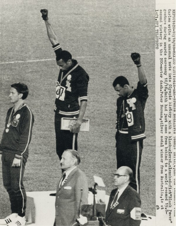 Title from caption on object: “Gold-And-Bronze Medalists Tommie Smith and USA Teammate John Carlos...”