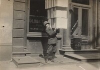 Wagon boy or "tail boy" helping to load the wagon, Lewis Hine, c. 1914