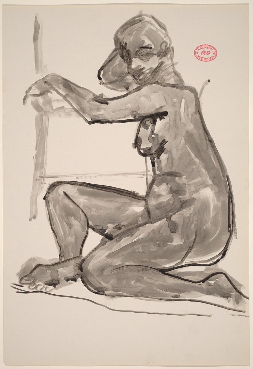 Untitled [female nude seated on floor resting arms on chair]