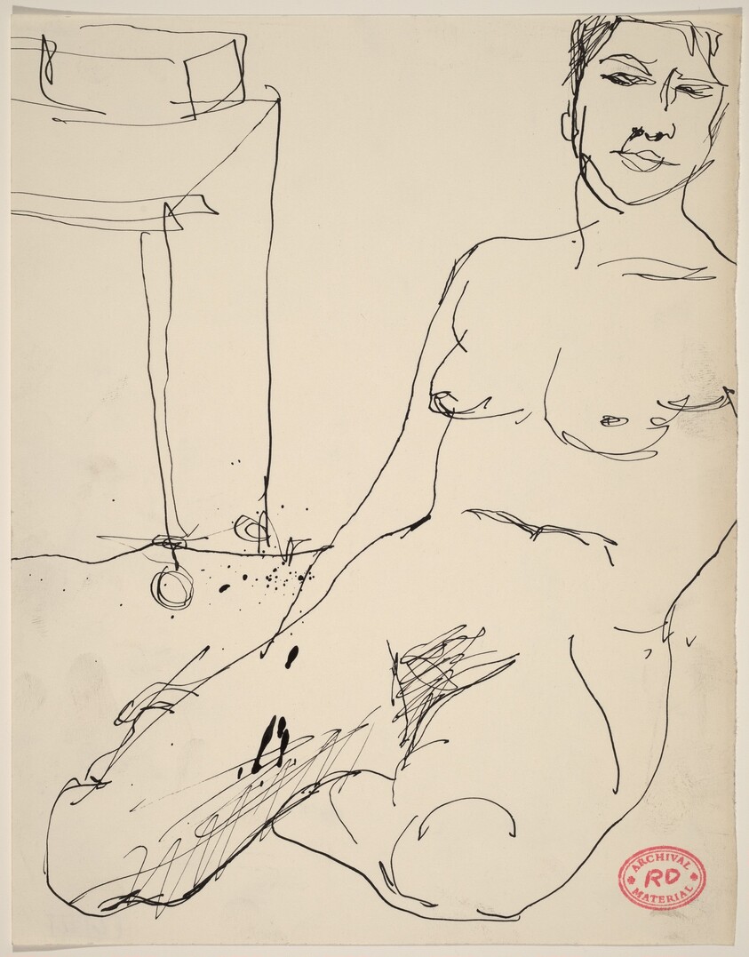 Untitled [female nude seated on floor near a table]