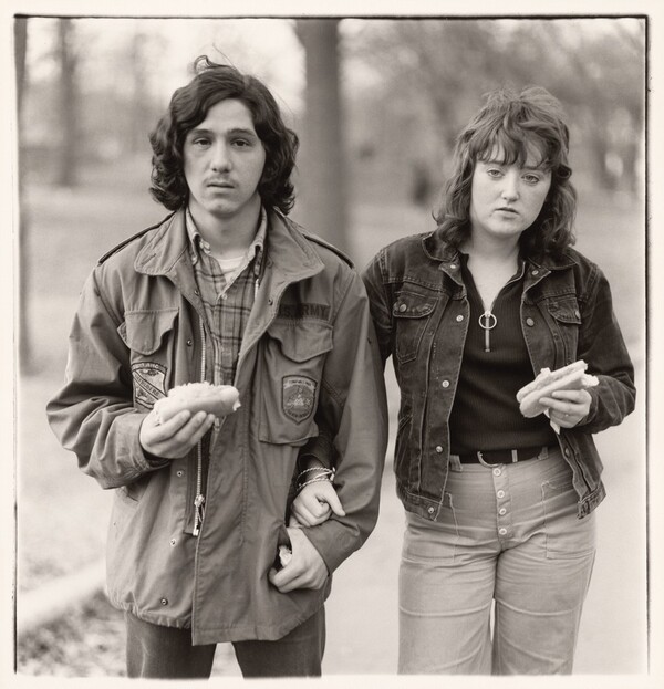 A young man and his girlfriend with hot dogs in the park, N.Y.C. 1971