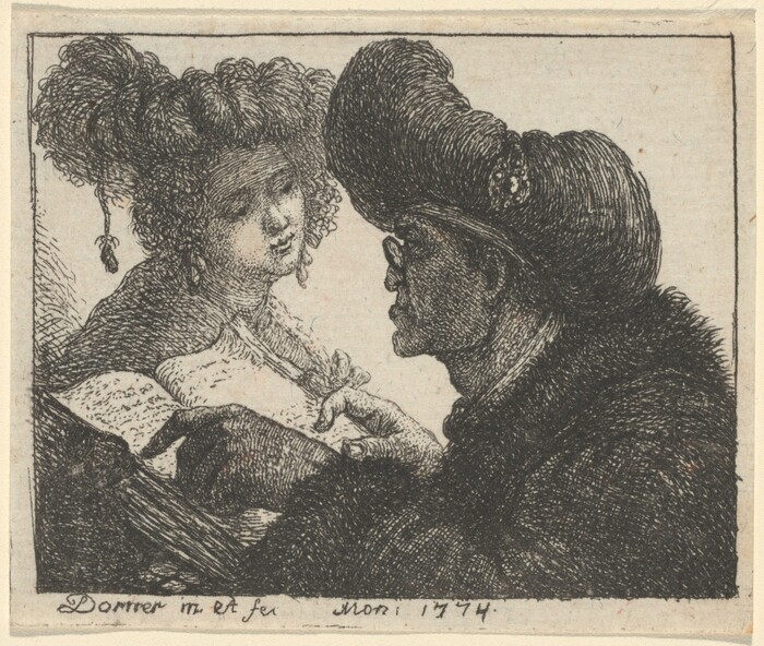 The image shows two figures from the waist up. The person on the left is positioned facing slightly towards the right, with their head tilted. This person has curly hair styled into an updo with ringlets hanging down and appears to be wearing an earring. They have a rounded face with a gentle expression and are wearing clothing with a ruffled collar. The second person, to the right, is seen in profile, wearing glasses. They are holding a quill or similar writing tool, pointing toward an open book with visible writing. The background is plain, focusing attention on the two figures.