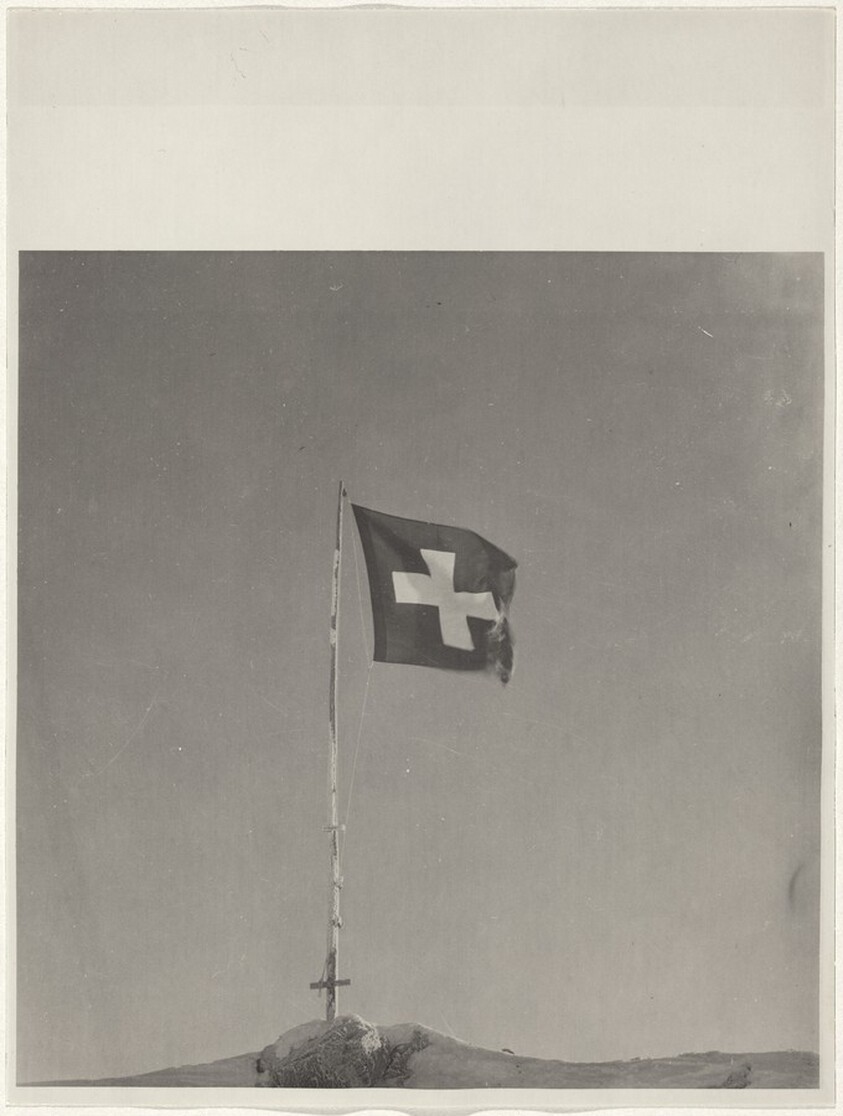 Swiss flag on mountain peak, Arosa