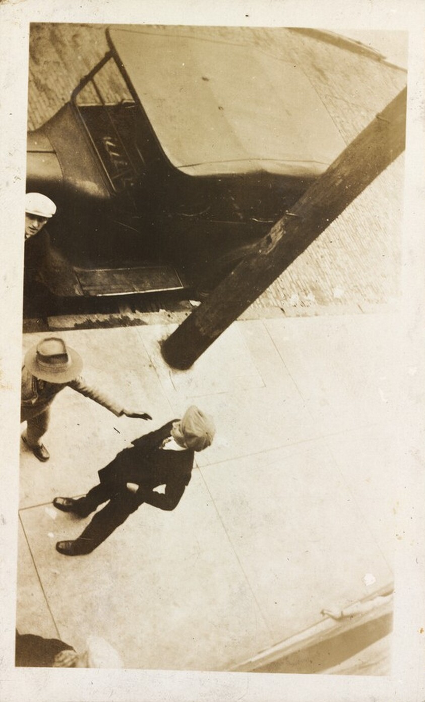 Untitled (Overhead view of men conversing on street)