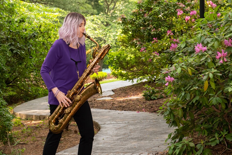 A woman playing the saxophone.