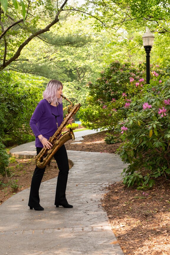 A woman playing the saxophone.