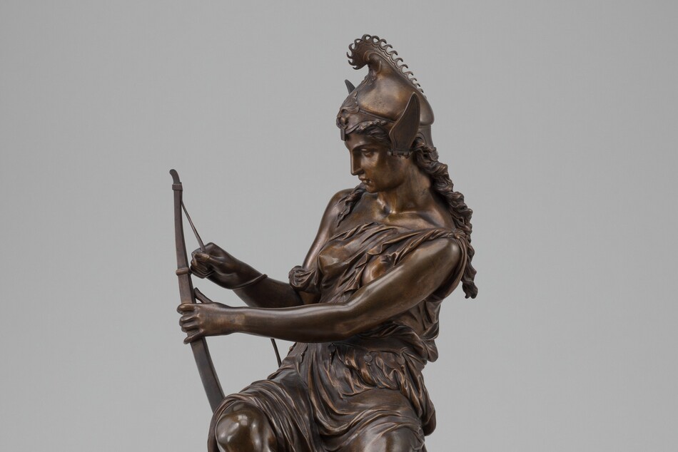 A woman holding a bow and arrow.