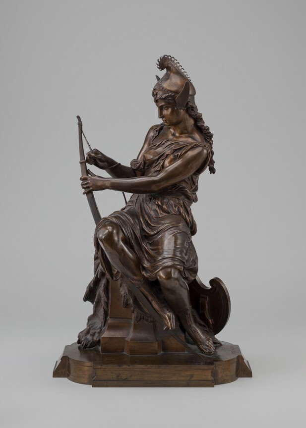 A woman holding a bow and arrow.