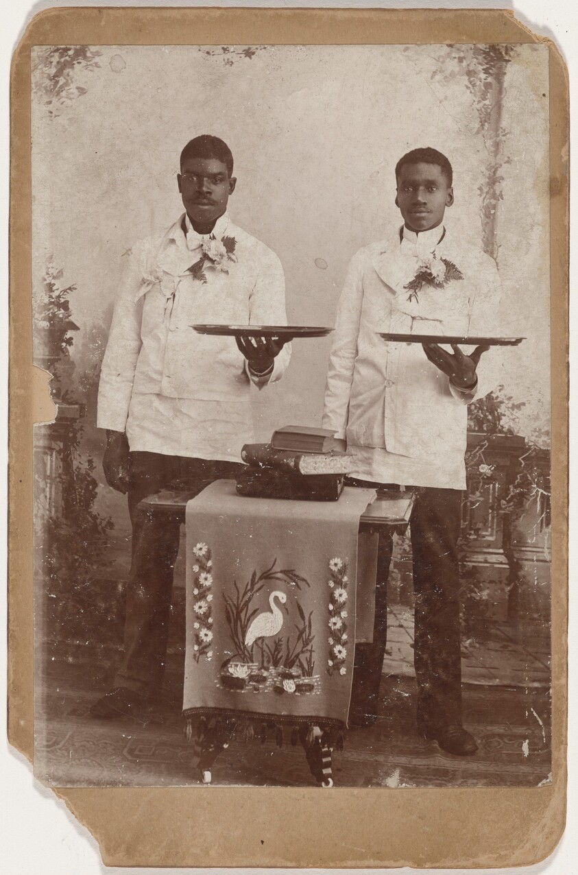 Portrait of Two Men Holding Trays