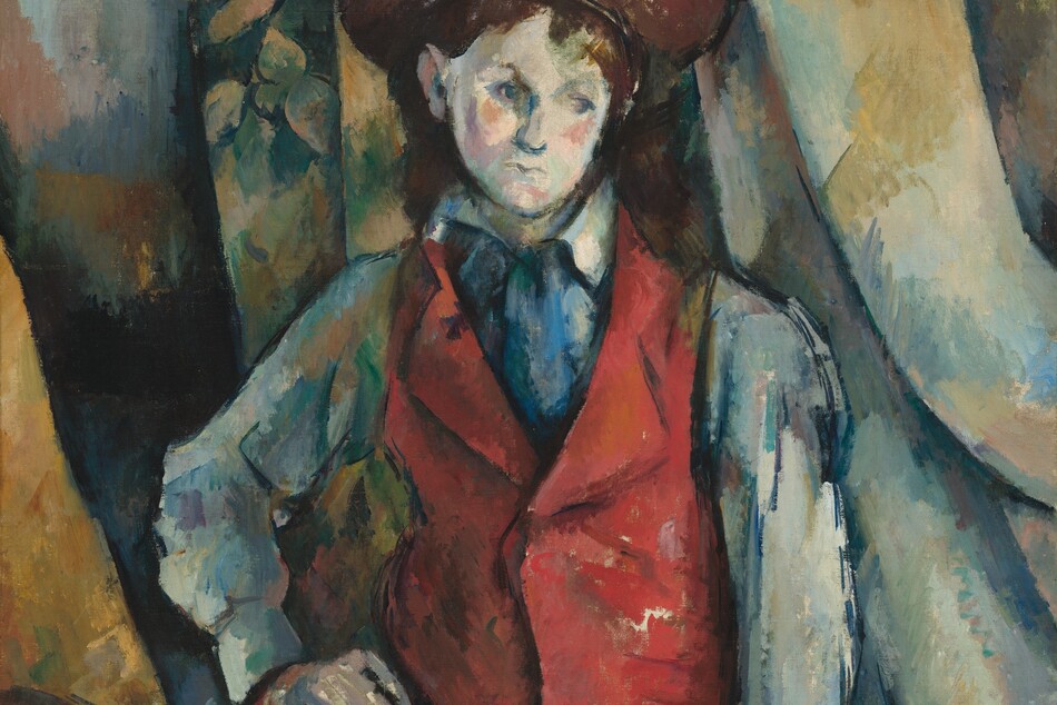 Shown from the thighs up, a boy wearing a crimson-red waistcoat stands against swags of fabric painted with visible strokes in white, sky blue, harvest yellow, and sage green in this loosely painted, vertical portrait. Painted with choppy brushstrokes, the boy has pale, ivory-white skin, blushing pink cheeks, pursed lips, faint eyebrows, and topaz-blue eyes that gaze down to our right. His shoulder-length, dark brown hair is tucked behind one ear under a brown wide-brimmed hat. His red waistcoat is worn over a long-sleeved, slate-blue shirt. The collar of his skirt is slightly flipped up on his right side, to our left, and a swipe of cobalt blue suggests a tie or scarf between the lapels. A band of sapphire blue could be a belt above olive-green trousers, and dashes of navy blue create shadows. His right hand, to our left, is planted on that hip. The other arm hangs straight and loose by his side, those fingertips almost brushing the bottom edge of the canvas. The boy’s body is outlined in dark blue. The drapery behind him falls in folds that sweep gently to our right. The background is painted with patches and swipes of cool blues and greens, and pale golden yellow. One swag of the drapery, over the shoulder to our left, is painted with a loose pattern suggesting leaves. One back post and a sliver of the curving back of a wooden chair peeks into the composition in the lower left corner.