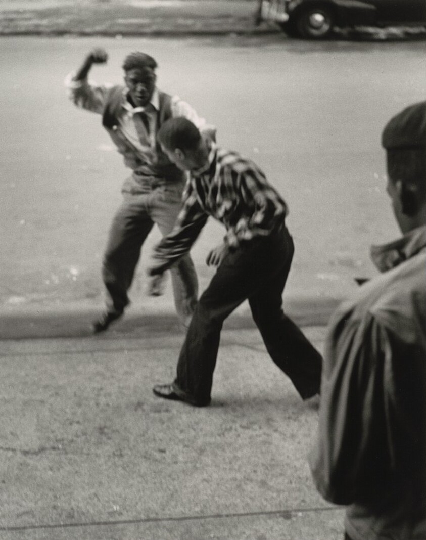 Red (in checkered shirt) has an argument with Sonny Hollis, his "War Counselor," and slugs it out with him to maintain authority