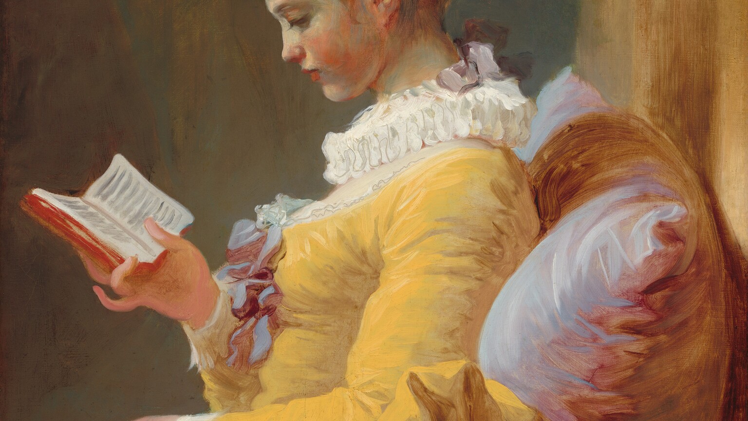 Shown from the lap up, a young woman with pale skin, wearing a goldenrod-yellow dress, sits reading a small book, facing our left in profile in this vertical painting. The deep, scooped neckline of her rich yellow gown is edged with lace and decorated with a mauve-purple bow at the bust. Her chest is covered by sheer white fabric under a ruffled, pleated collar. The ruff is tied at the back with another mauve bow, and a ribbon of the same color ties up her chestnut-brown hair. She has a delicate nose and rosebud mouth, and she tips her head down to read the book she holds in one hand. She sits against an oversize pillow streaked with pale lilac and deep rose pink. Her left arm, closer to us, is draped over a railing that extends across the width of the canvas. The background behind her is streaked with tan and muted teal blue. A vertical strip of light caramel brown along the right edge of the canvas suggests another wall against which the pillow rests. The artist’s loose, lively brushstrokes are visible throughout.