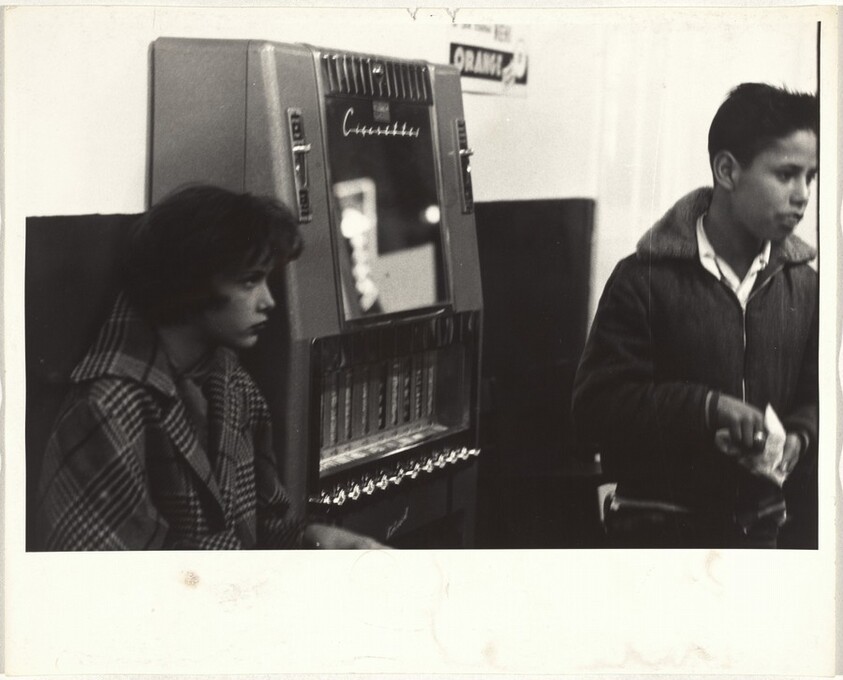 Couple by cigarette machine--New Mexico