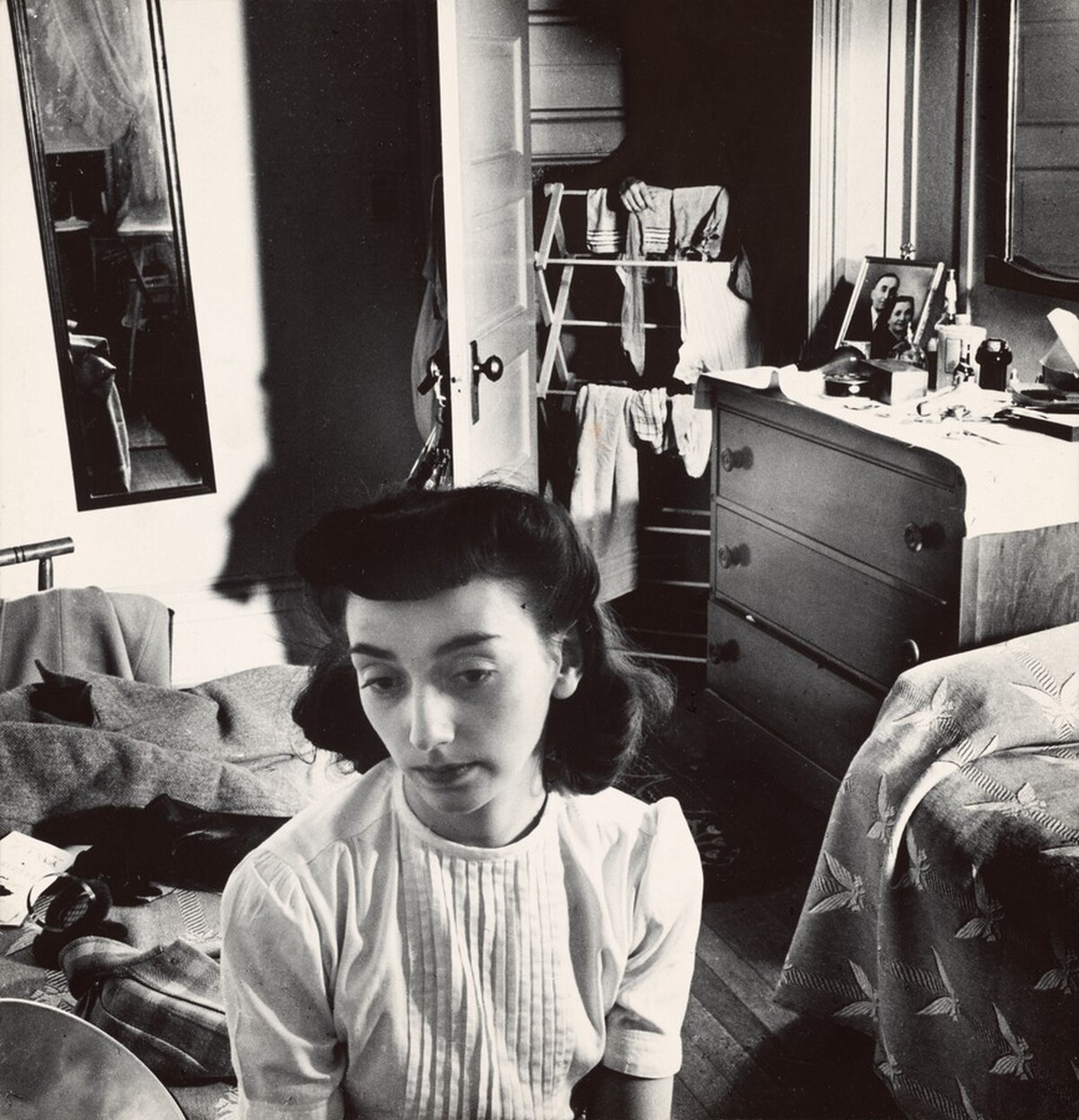 Young woman in the doorway of her room at a boardinghouse, Washington, DC