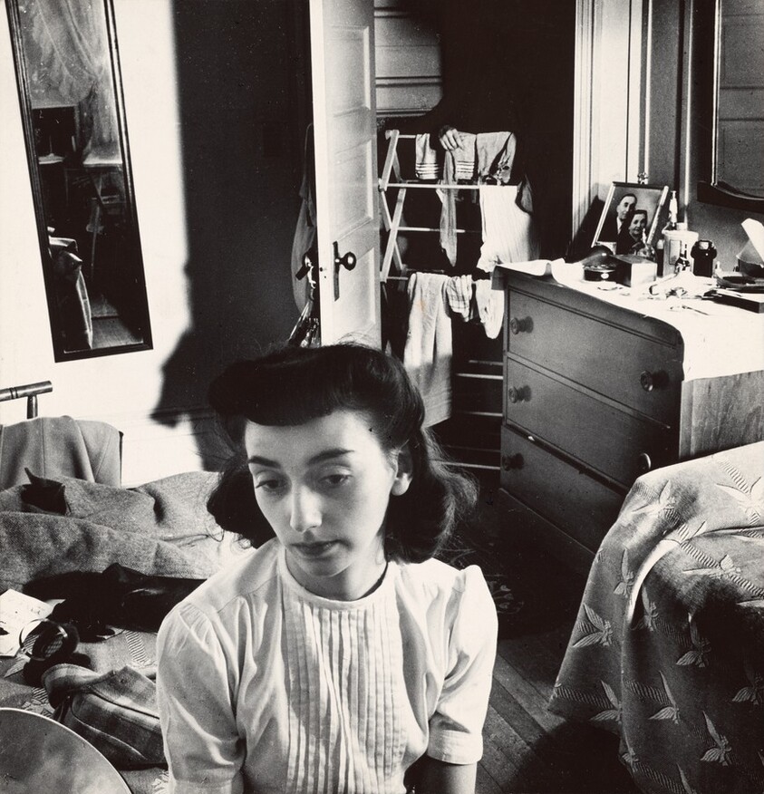 Young woman in the doorway of her room at a boardinghouse, Washington, DC