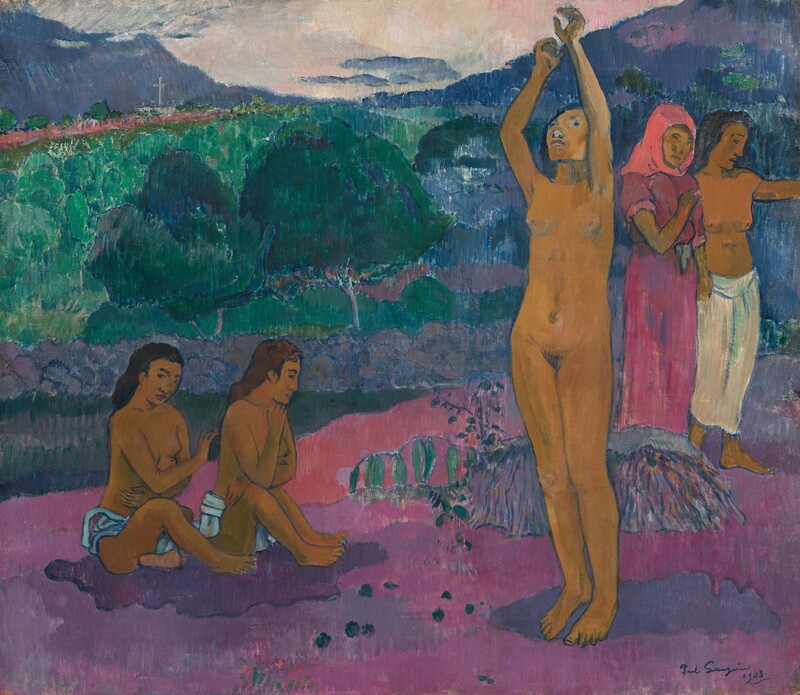 Five women, all with brown skin, sit and stand in a landscape painted with tones of emerald green, mauve pink, lilac and plum purple, and cobalt blue in this horizontal composition. To the right of center, a nude woman stands on a patch of violet-colored ground with both arms overhead, as she looks up. To our left, two women wearing only pale blue cloths around their waists sit side-by-side on a patch of amethyst-purple ground. Both sit with their bodies angled to our right, and they look toward the ground with their arms across their chests. To our right of the standing woman, the final pair of women stand or walk toward the right edge of the painting. The woman to our left in that pair wears a dusky rose-pink dress and a bright, coral-pink head covering. She holds one arm across her chest, elbow bent. Next to her, the fifth woman is bare-chested with a white cloth tied around her waist, covering her legs. She looks to our right and holds up her arm, which extends off the right edge of the composition. The purple patches on the ground are surrounded by other areas of raspberry pink and mauve. A band of trees and vegetation stretches across the background, leading back to cobalt-blue mountains along the horizon. Mountains to each side of the composition brush the top edge, and the shallow U of sky between them is ivory white. The artist signed and dated the painting in the lower right corner, “Paul Gauguin 1903.”