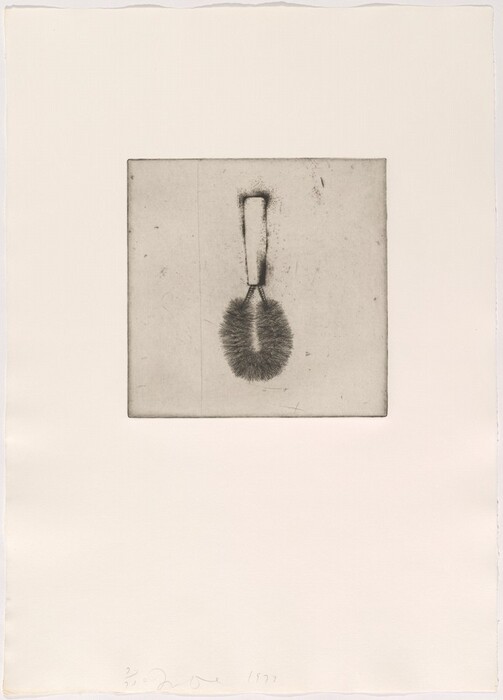 The image displays a sketch of a brush within a square frame on a blank background. The brush has a rectangular handle and a rounded bristle section. The color scheme is limited to shades of grey and black.