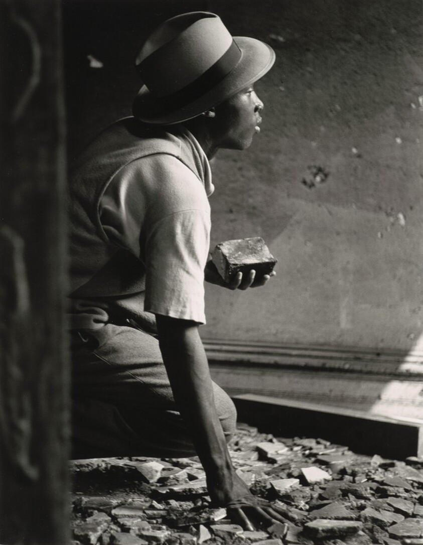 Nomad holds brick during siege in old house