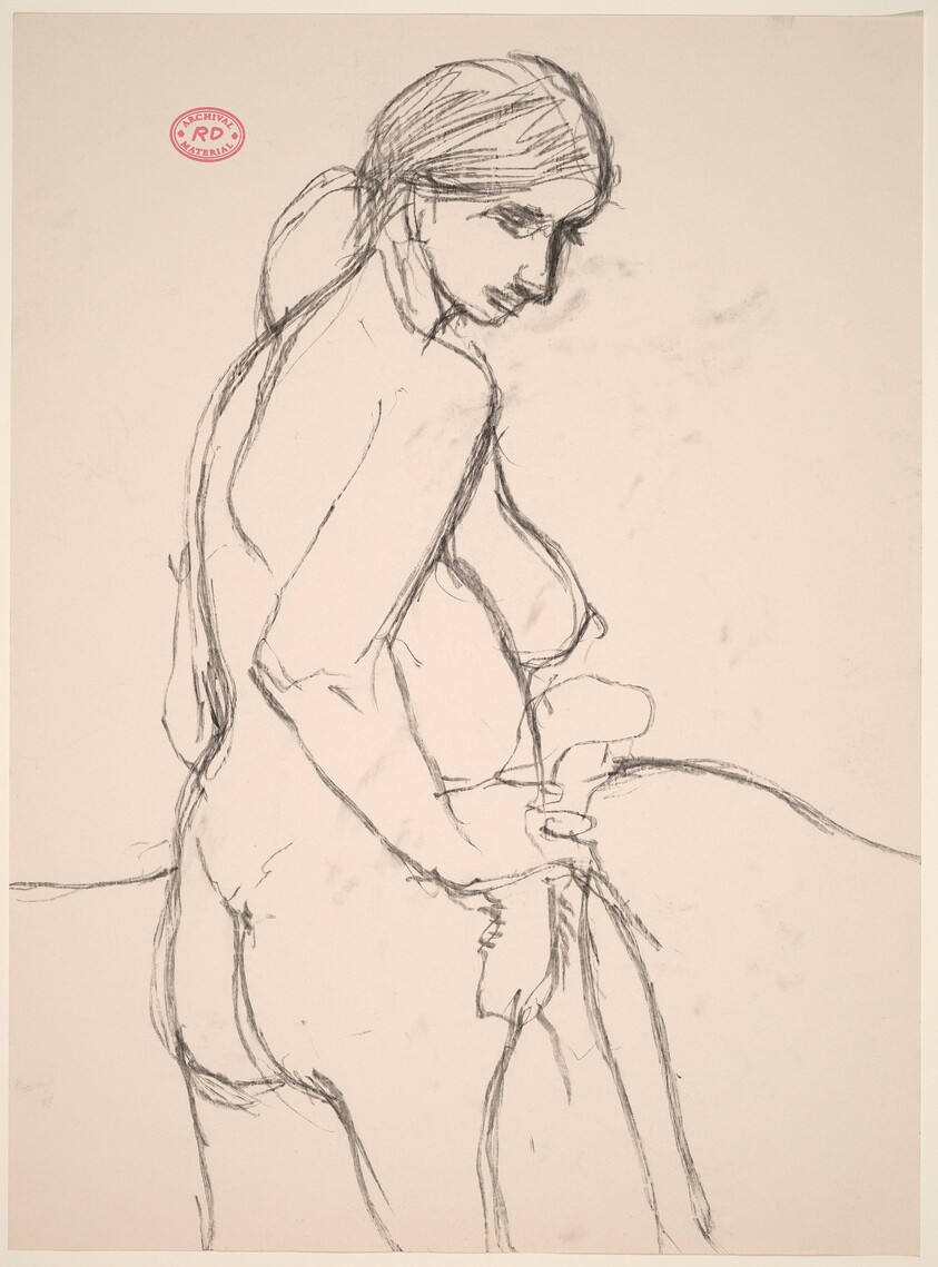 Untitled [side view of a standing female nude turning toward the viewer and looking down]