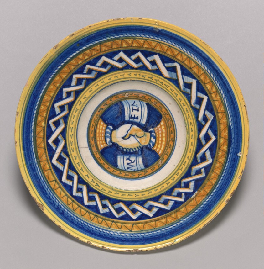 Plate with clasped hands