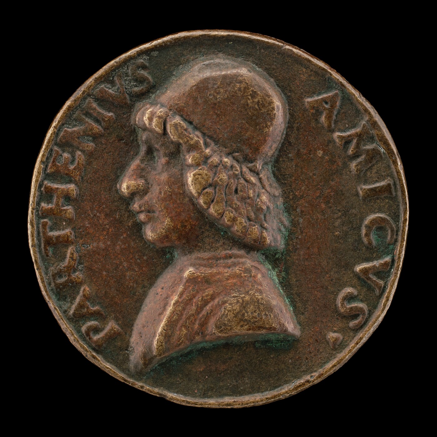 The sculpture is a relief on a medallion depicting the profile of a person's head and shoulders. The individual shown is wearing a hat and has curly hair extending from underneath, a prominent nose, and lips. The medallion is circular with a dark background, made of a material resembling bronze, and has an inscription that partially reads "PARTHEMVS AMICVS."