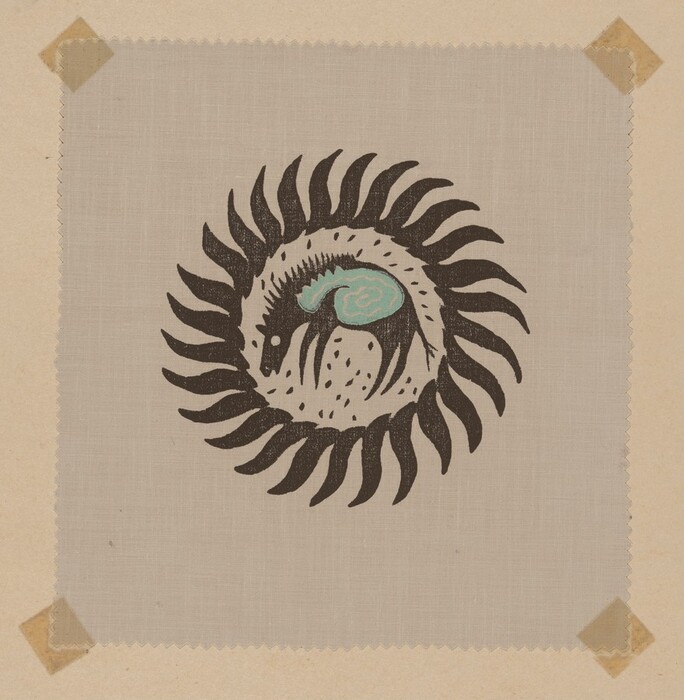 A circular pattern is formed by black, swirling shapes radiating outward. Within the circle is a stylized figure resembling a horse or quadruped with a curved back. The figure has a blue, cloud-like shape on its back. The background is textured and the image appears to be taped to a surface.