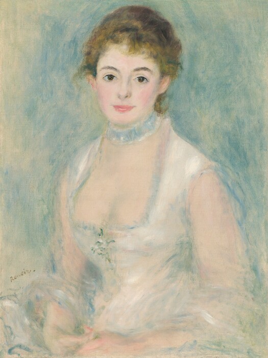 Shown from the hips up, a pale-skinned young woman wearing a white dress sits smiling gently at us in this vertical portrait painting. Blended strokes of pearl white, cool green, and muted blue create an overall soft, almost blurred look. The woman’s body is angled to our left, but she turns her face to look at us with brown eyes under dark, curved brows. She has a heart-shaped face with rosy cheeks, a thin, short nose, and full, pink lips, which are closed in a smile. Her honey-blond hair is swept up and back, but a few tendrils curl on her forehead and the nape of her neck. The neckline of her sleeveless white dress is cut low. The bodice fits tightly to a narrow waist, and a sprig of flowers is suggested by a few strokes of fern green and bright white at the center of the chest. A pale blue collar or ruffled band encircles her neck like a choker. Her hands rest together in her lap, and a white cloth loops over her forearms. The background is painted with loose strokes of powder blue and sage green against the off-white of the canvas, which is visible in some areas, especially along the left edge. The artist signed the painting near the woman’s elbow to our left, “Renoir.”